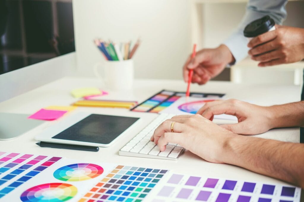 Graphic designer drawing on graphics tablet at workplace
